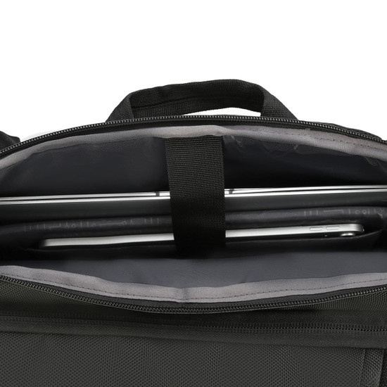 A black backpack interior featuring a sleek laptop compartment and grey lining. It includes a brand logo.
