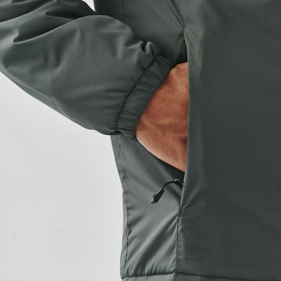 A dark green thermal jacket with a hand in the side pocket. The jacket features elasticated cuffs and a smooth exterior.