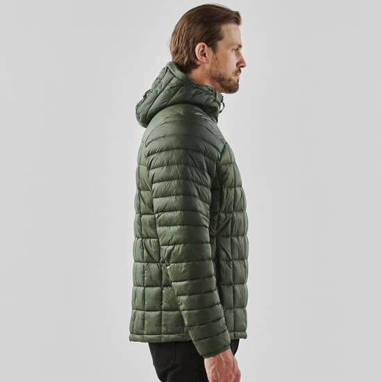 A olive green puffer jacket with a hood, featuring a quilted design. It has a logo on the garment.