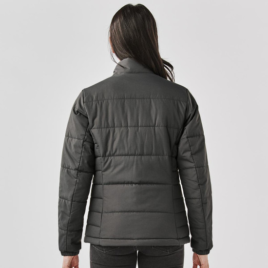 A women's puffer jacket in dark grey, featuring a quilted design and a high collar. It includes a logo on the back.