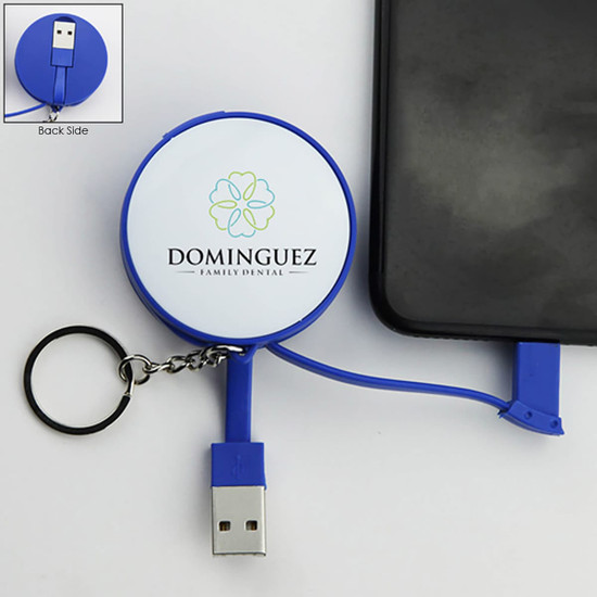A blue charging cable key ring with a retractable USB connector, attached to a smartphone. It features a logo on the front.