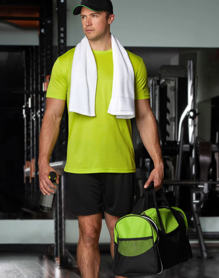 A sports travel bag in black and green, held by a person in a bright green athletic outfit with a towel draped around their neck.