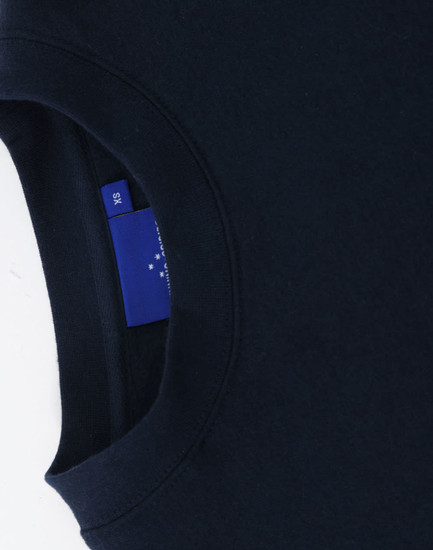 A navy crewneck sweatshirt with a ribbed collar and a logo tag visible on the inside seam.