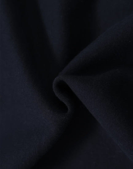 A close-up of dark navy fabric, showcasing the soft texture of a fleecy hoodie material.