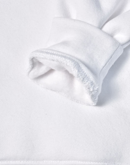 A close-up of a white fleecy hoodie sleeve featuring a soft, textured cuff. It has a logo on the fabric.