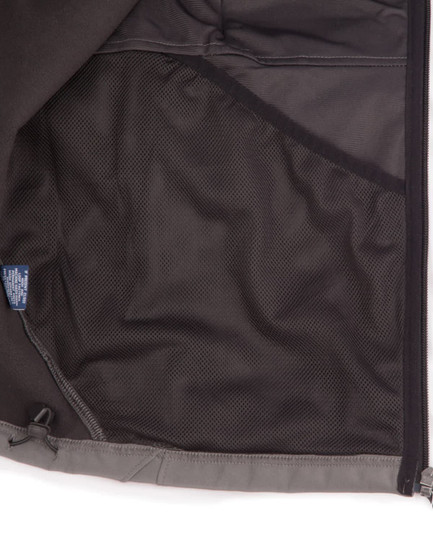 An inside view of a men's softshell high-tech jacket featuring a mesh pocket, predominantly grey in colour.