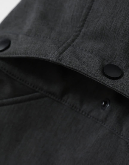 A men's softshell full zip hoodie in grey, featuring a hood and a logo on the inner collar.