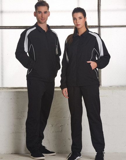 A black track jacket featuring white accents, displayed on a male and female model. The jacket has a logo.