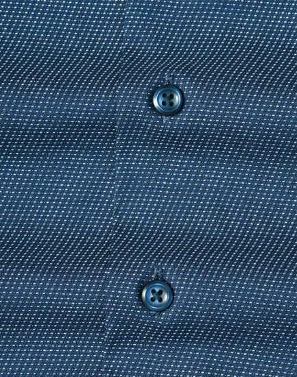 Men's long-sleeve button-up shirt in navy with a pin dot pattern and contrasting buttons. Features branding.