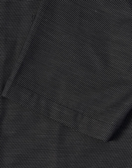 A close-up of a men's black pin dot stretch short-sleeve shirt featuring a pocket and a textured fabric.