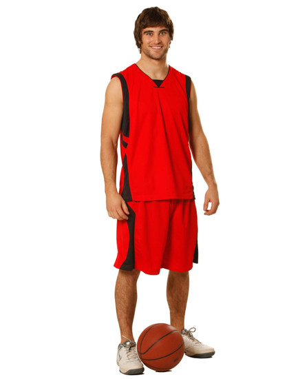 A model wearing red basketball shorts and a matching sleeveless jersey, standing beside a basketball.