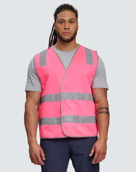 A bright pink safety vest with reflective shoulder tapes, featuring a plain design and worn by a male model.
