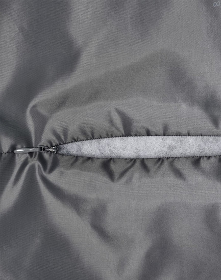 A close-up of a grey quilted fabric with a zip closure, highlighting the texture and stitching details.