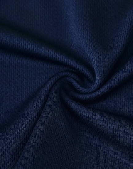A close-up of navy blue Cooldry fabric with a textured finish, featuring a slight sheen and breathable design.