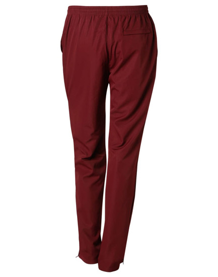 Maroon adult track pants with an elastic waistband and a rear pocket. Features branding on the fabric.