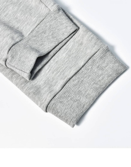 A close-up of grey poly/cotton terry sweat pant cuffs featuring ribbed texture and stitching details.