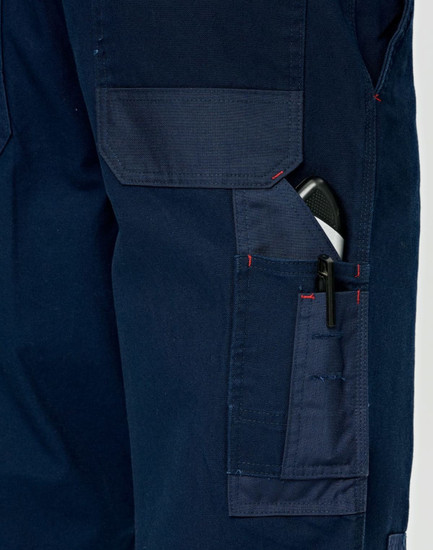 A close-up of navy blue work pants featuring multiple pockets, including a pen pocket, with visible stitching details.