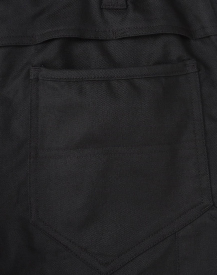 A close-up of black cotton stretch ripstop work pants, featuring a back pocket design and fabric texture.