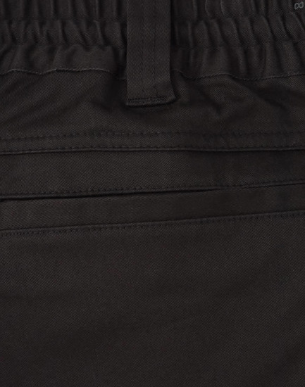 A close-up of black cotton stretch drill work shorts, featuring an elastic waistband and pockets.