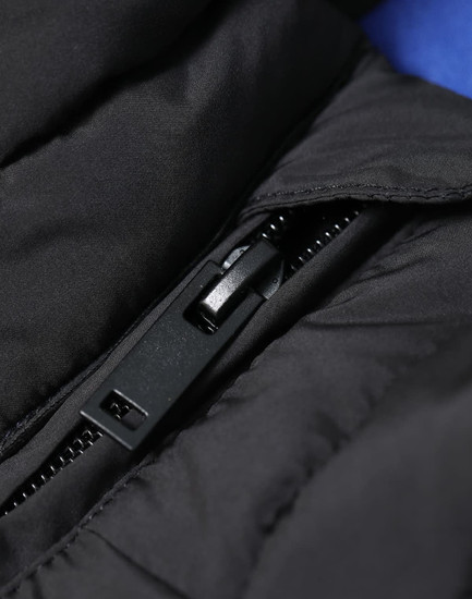 A close-up of a black insulated puffer vest showcasing the zipper and stitching details.