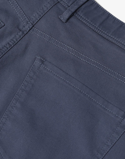Men's flexi chino pants in grey featuring detailed stitching and a back pocket design. Includes branding on the waistband.