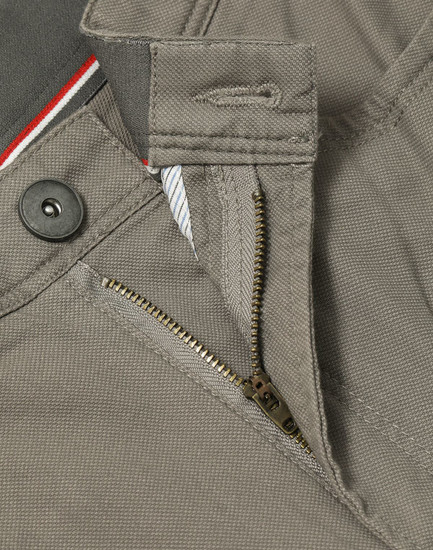 A close-up of grey Men's Jean Style Flexi Chino Pants featuring a zipper and button closure.