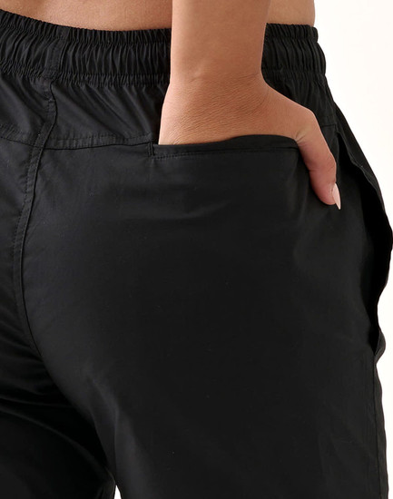 Black unisex mercerised cotton shorts featuring an elastic waistband and side pockets.