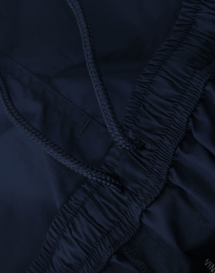 Navy unisex mercerised cotton shorts featuring an elastic waistband with a drawstring. Includes a logo detail.