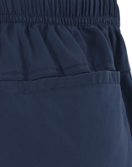 Unisex mercerised cotton shorts in navy, featuring an elastic waistband and a pocket design.