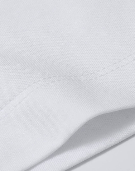 A close-up view of a white cotton t-shirt, showcasing its fabric texture and stitching details.