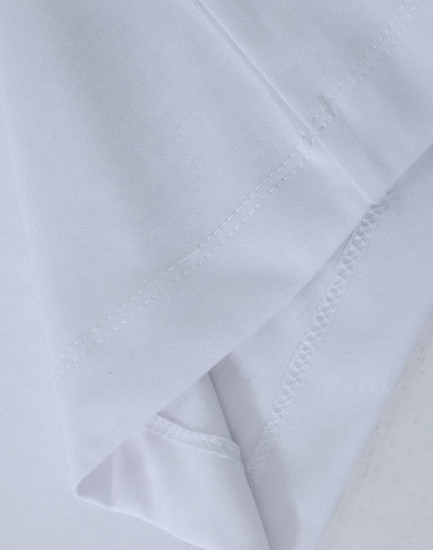 A close-up of a white premium cotton long-sleeve T-shirt showcasing its fabric texture and stitching details.