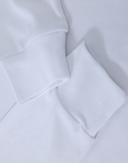 A white long-sleeve tee shirt with cuff details, featuring a subtle logo.