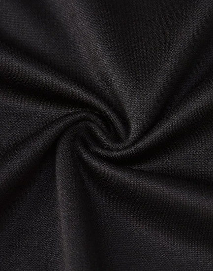 A close-up of black fabric, showcasing a smooth, textured surface suitable for a polo shirt.