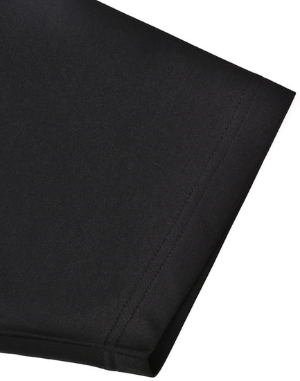 A close-up of the sleeve of a black sustainable poly/cotton polo shirt featuring a logo.