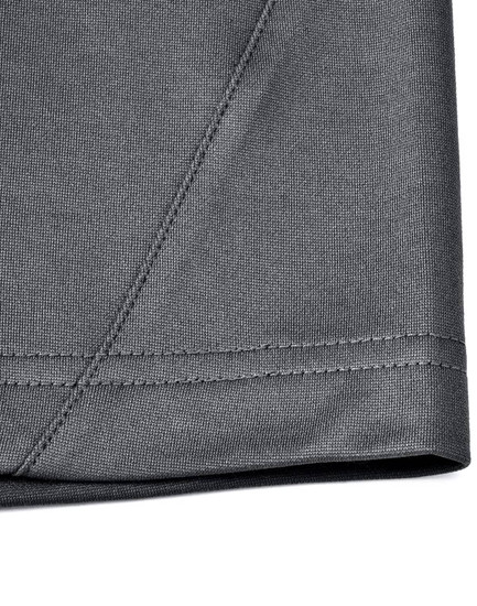 A close-up of the hem and stitching of a grey polo shirt made from sustainable poly/cotton fabric.