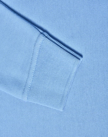 A light blue long sleeve polo shirt made from poly/cotton pique knit, featuring ribbed cuffs.