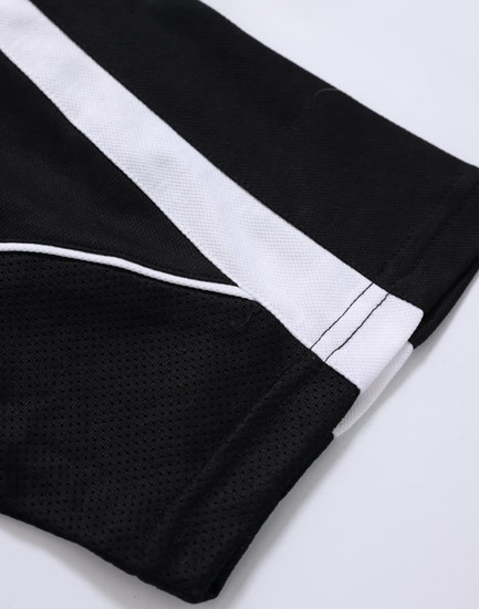 A close-up of a black polo shirt featuring white accents and a logo.