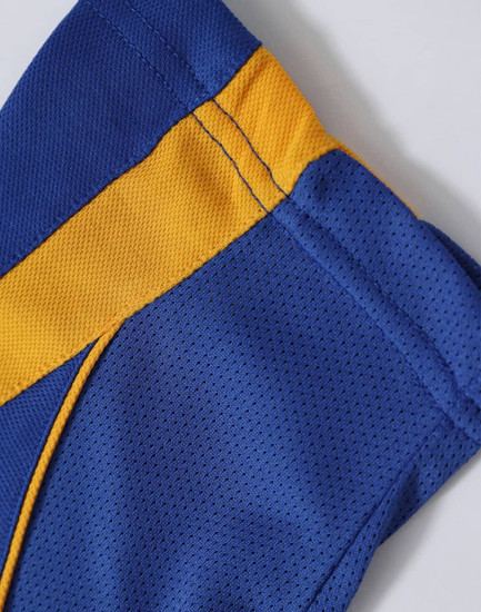 A close-up of a blue and gold polo shirt featuring a mesh fabric design and stitching details. The shirt has a logo.