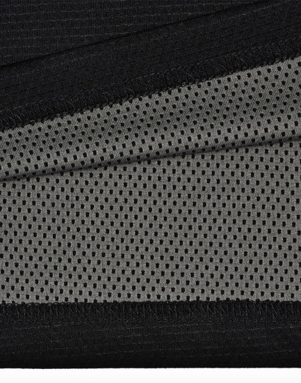 A close-up of black and grey fabric, featuring a textured surface and mesh pattern, ideal for polo shirts.