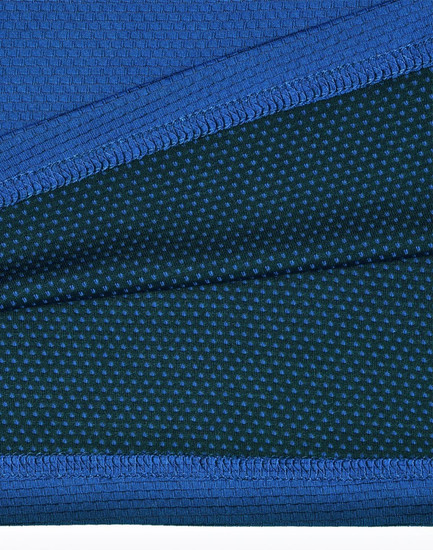 A close-up of a blue and dark green polo shirt featuring a textured fabric and a logo.