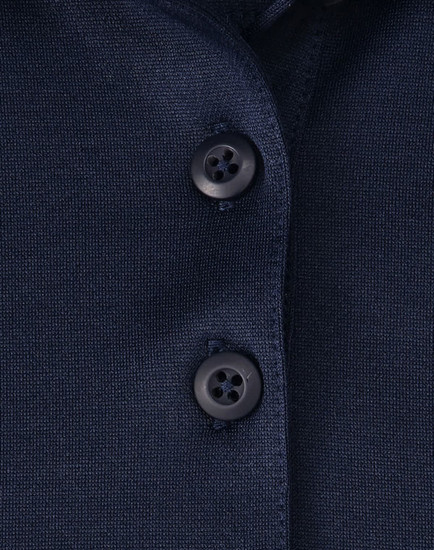 Close-up of a navy blue polo shirt featuring a button placket and a logo.