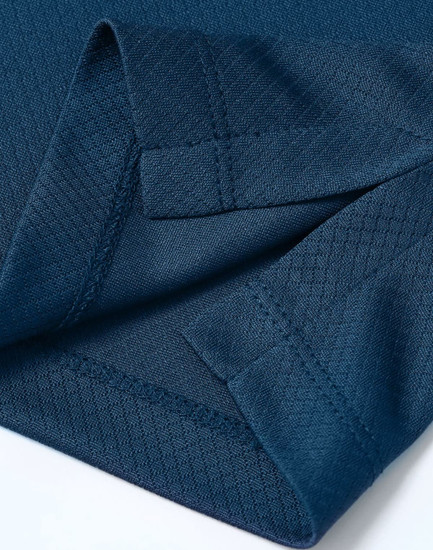 A close-up of a deep navy Jacquard knit fabric with detailed stitching and an edge finish. Features a branding logo.
