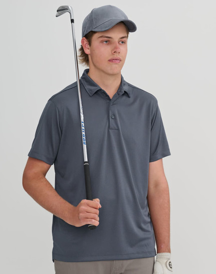 A young man holds a golf club while wearing a grey sustainable jacquard knit polo shirt and a matching cap.