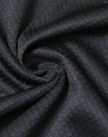 A close-up of a black jacquard knit fabric, showcasing its textured pattern and soft material.
