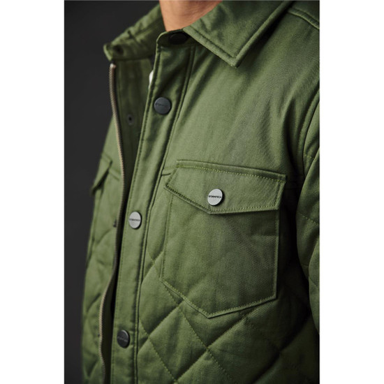 A green quilted jacket featuring chest pockets and snap buttons, presented on a dark background.