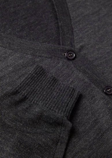 A grey women's button front knit cardigan featuring a pocket and button detail. It includes a logo.
