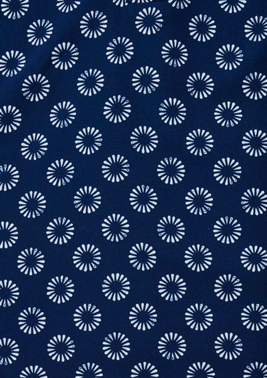 A navy tunic featuring a daisy print pattern in white. Includes a logo.