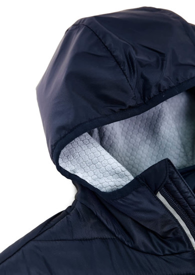 A unisex soft shell jacket in navy blue with a hood and a textured light grey lining. Features a logo on the jacket.