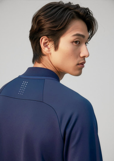 A navy unisex mid-layer top with a subtle logo on the back, featuring a high collar and modern design.