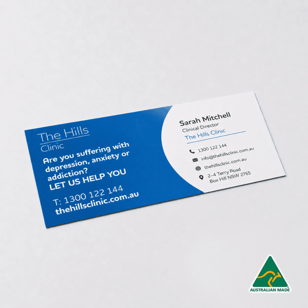A rectangular clinic business card featuring blue and white colours, with a logo and contact information.